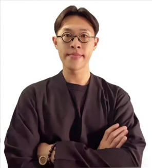 WaiTo, makeup artist and brow specialist, wearing a dark jacket with arms folded